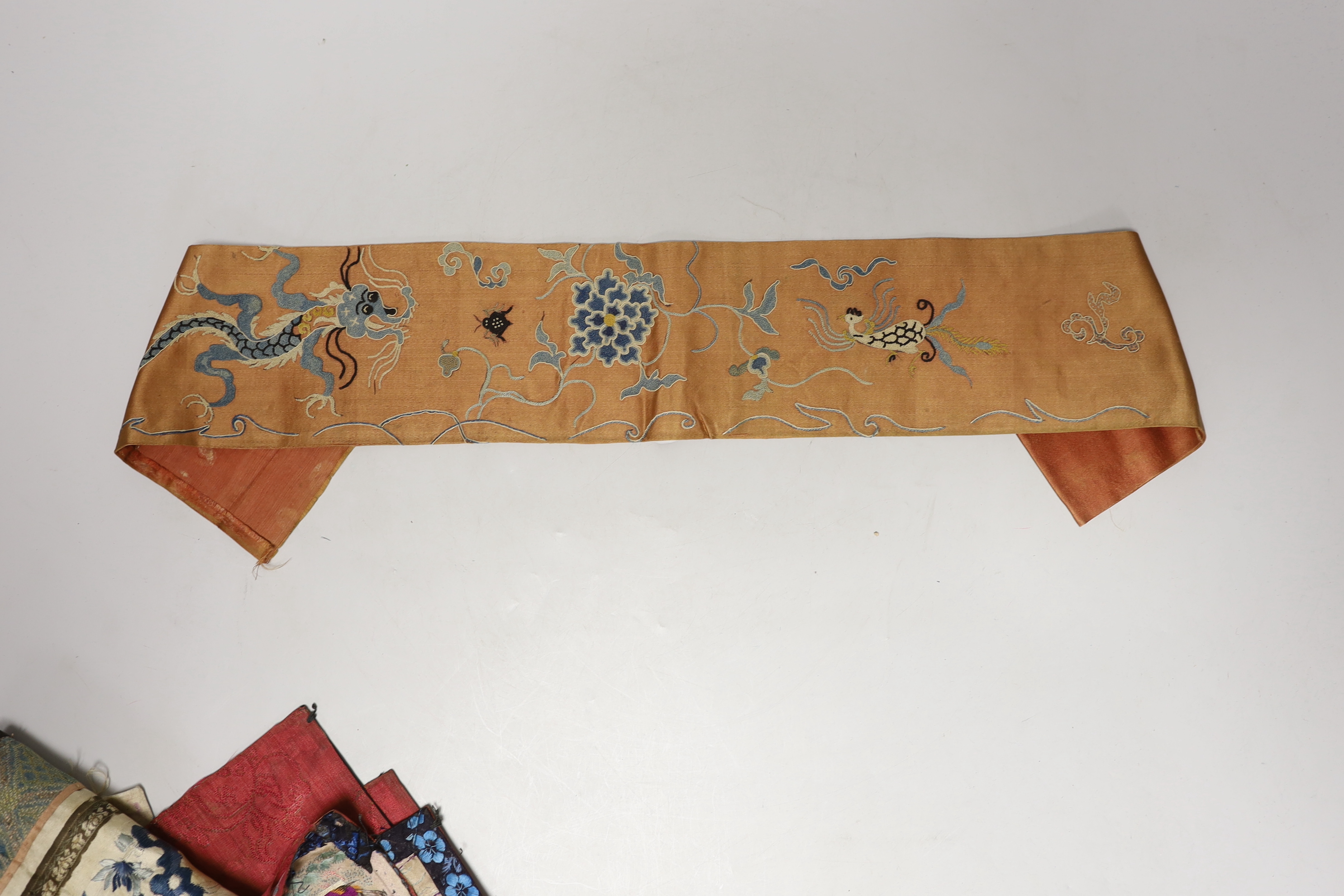 Three late 19th century Chinese silk embroidered panels, possibly made from sleeve bands, together with another pair of later embroidered sleeve bands and three other embroideries